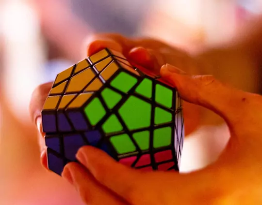 person solving a hexagon shaped rubik's cube
